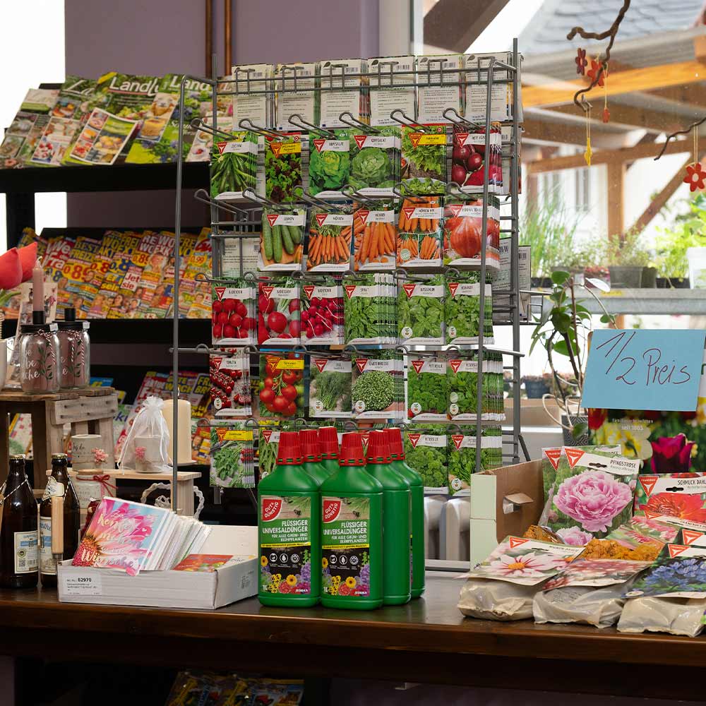 A newsstand with a wide selection of gardening magazines and seed packets.