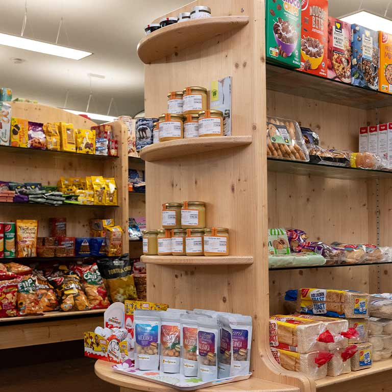 A well-stocked store with shelves full of colorful food packaging.