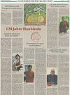 A newspaper features articles and photos with captions in German.